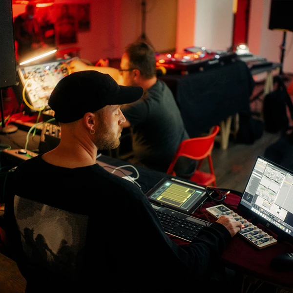 visual artist highpitchedblack looking at laptop screen